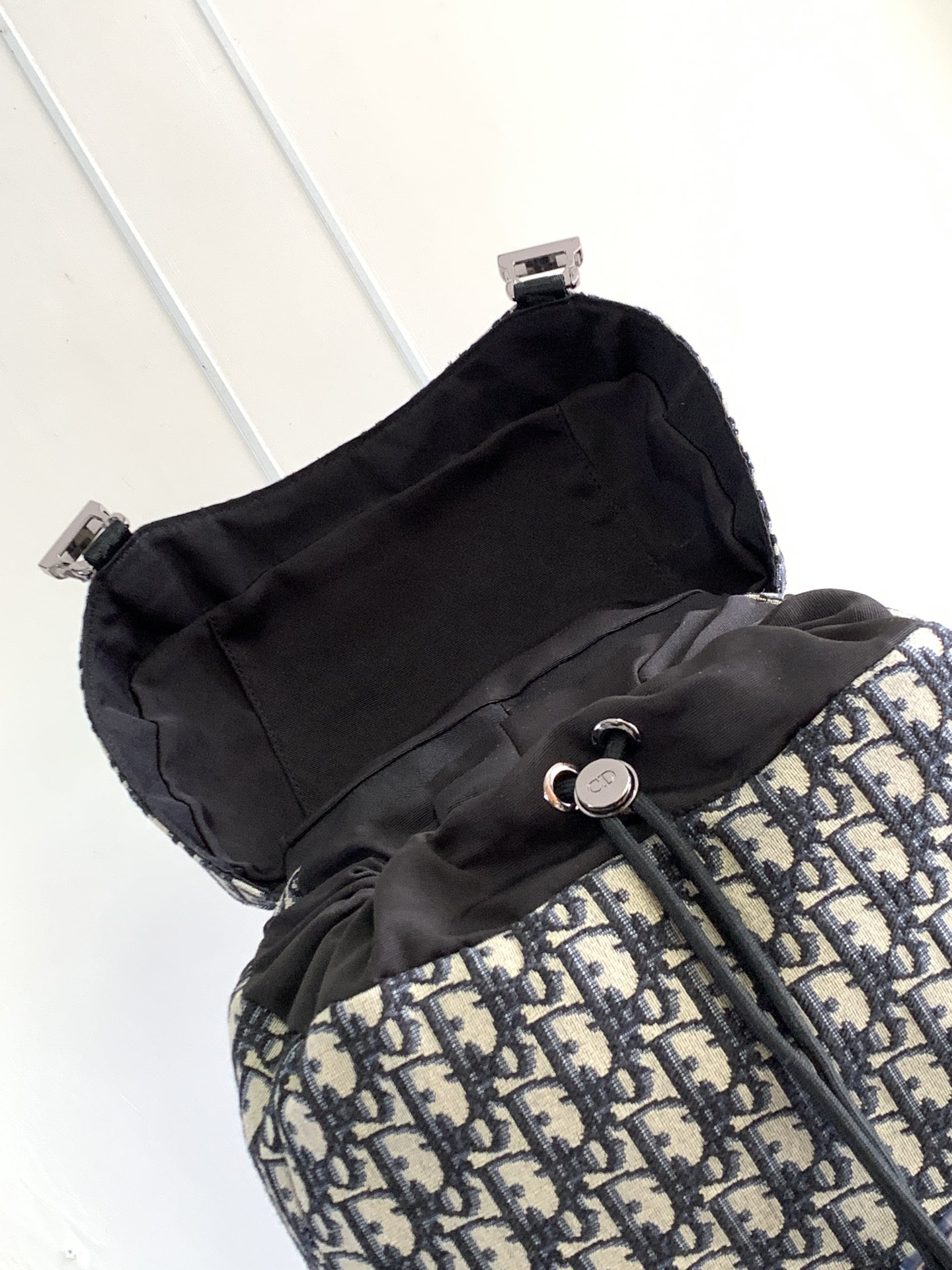 D*or 8 backpack with flap beige and black D*or oblique jacquard 31 x 48 x 16.5 cm