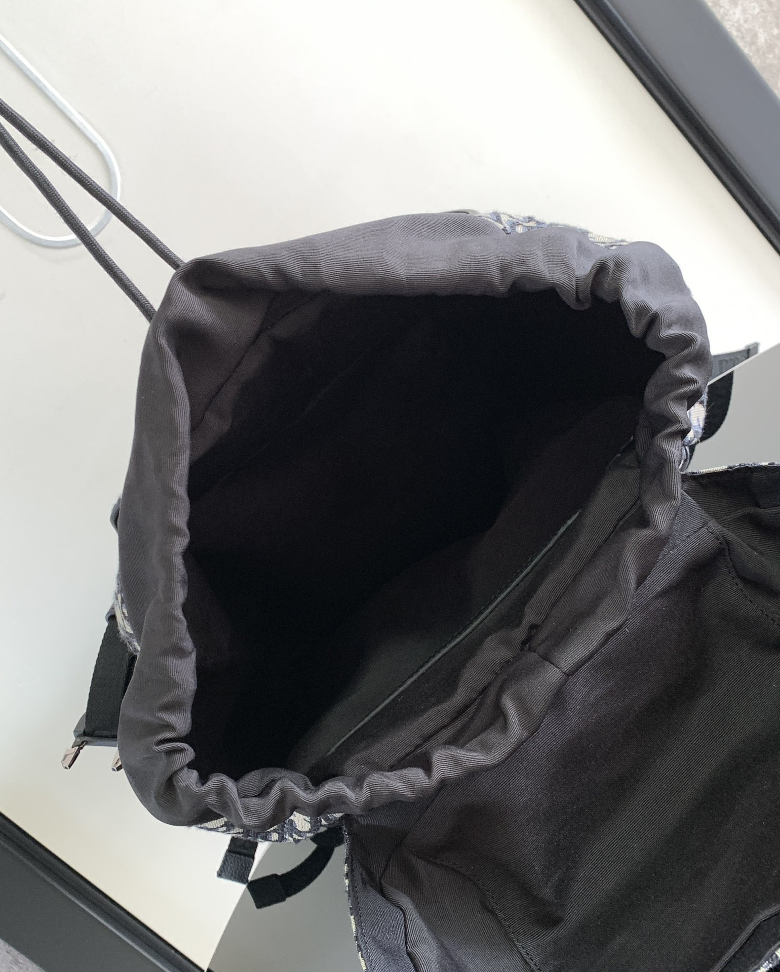 D*or 8 backpack with flap beige and black D*or oblique jacquard 31 x 48 x 16.5 cm