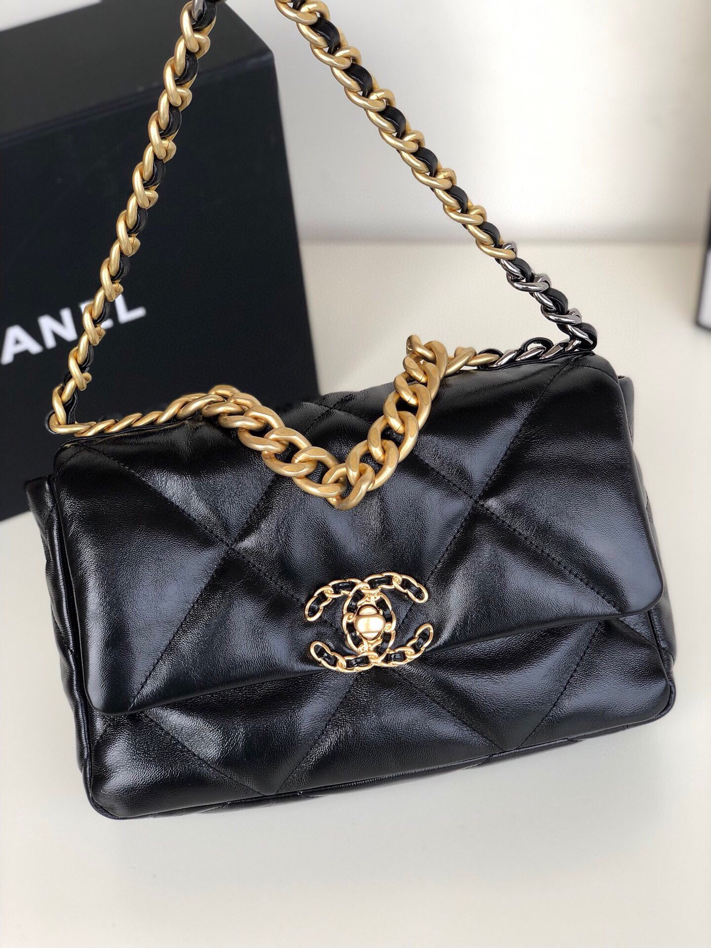 Ch**el 19 HANDBAG Shiny Leather, Gold-Tone, Silver-Tone & Ruthenium-Finish Metal Black 6.2 × 10.1 × 3.5 in